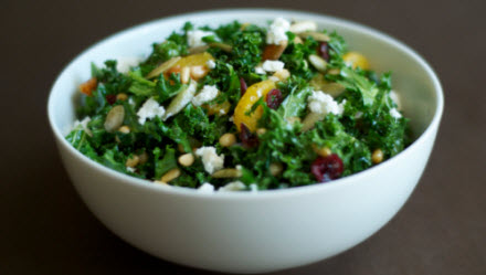 Raw kale salad with feta, pine nuts and cranberries