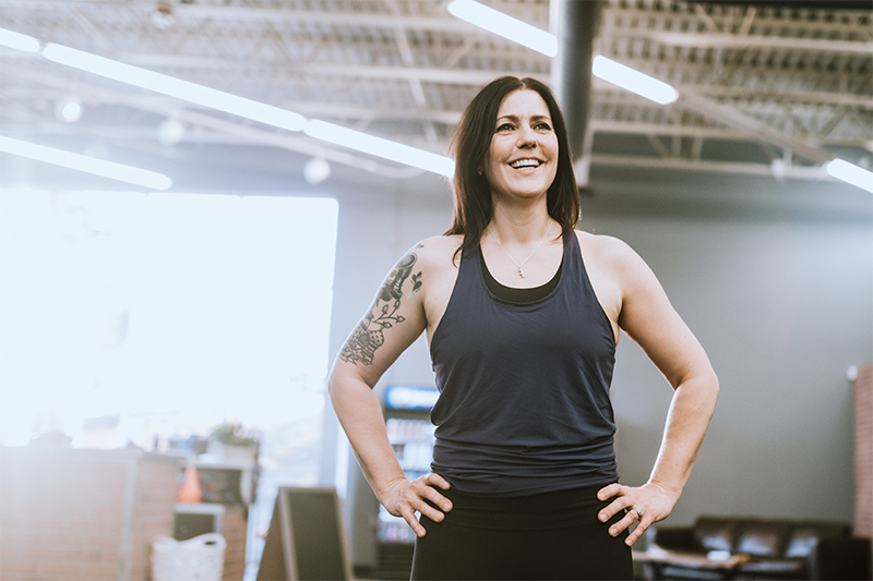 A woman prepares for a workout at her gym. 