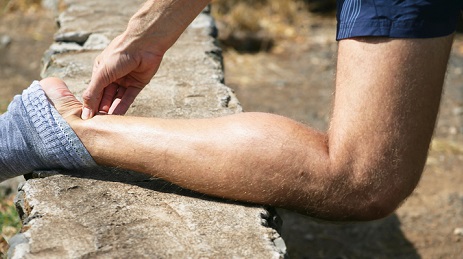 A runner holding his Achilles tendon. 