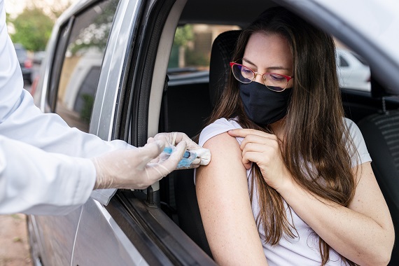 woman getting vaccinated at drive-up COVID-19 vaccine clinic