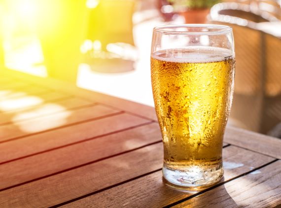 photo of a glass of beer in the summer sun