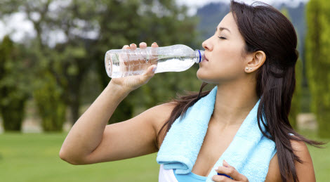 Woman drinking electrolytes after a work out.