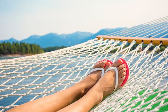 photo of a woman's feet resting in a hammock