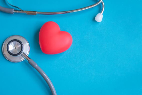 photo of a stethoscope next to a red heart
