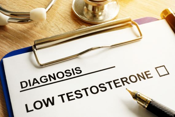 clipboard with a paper that shows a diagnosis of low testosterone