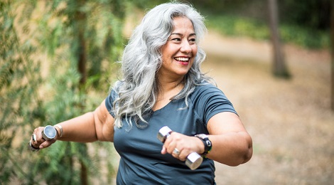 Woman walking while carrying weights.