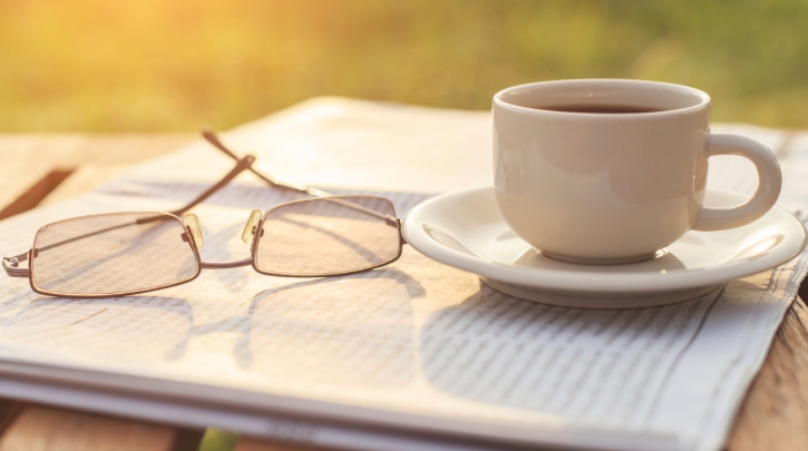 Newspaper, coffee, and glasses.