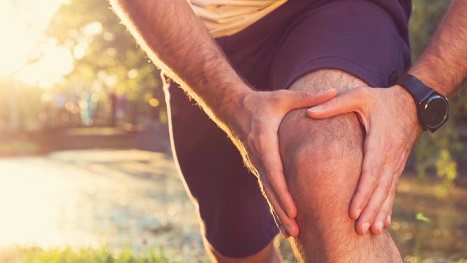 A runner holding his knee.