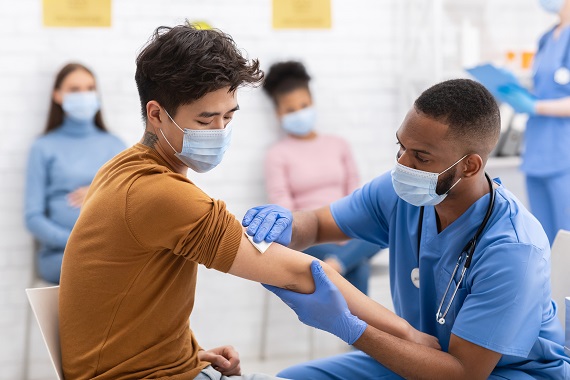 young man getting a vaccine