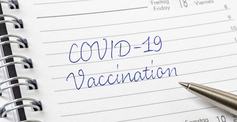 image of planner with COVID-19 vaccination written in it