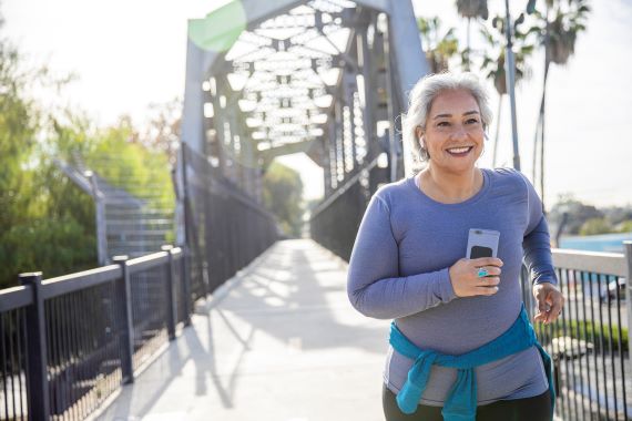 photo of a woman jogging on a bridge