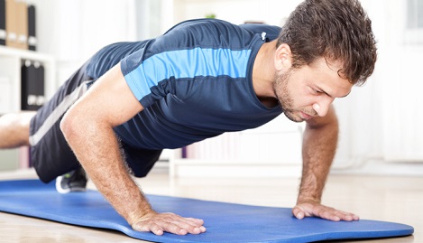 Man doing push-ups at home.