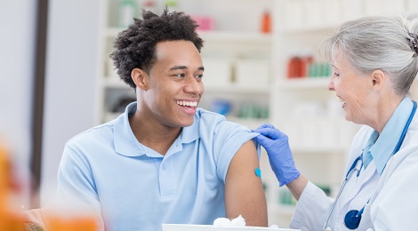 Patient getting a flu shot from his doctor at the hospital.