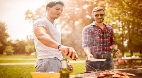 Two guys grilling in a park