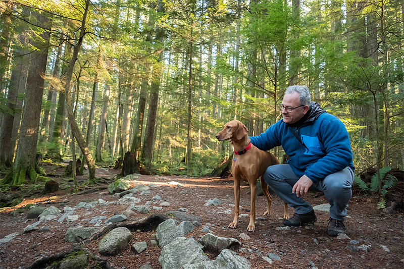 Man and dog hiking in the woods