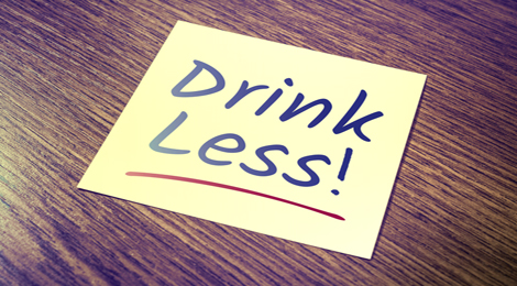 A sign reading drink less.