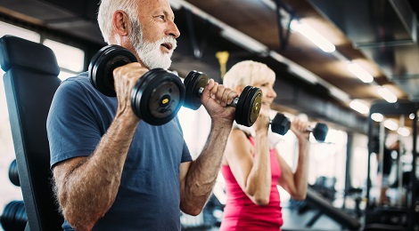 Couple with Alzheimer's disease exercising in a gym.