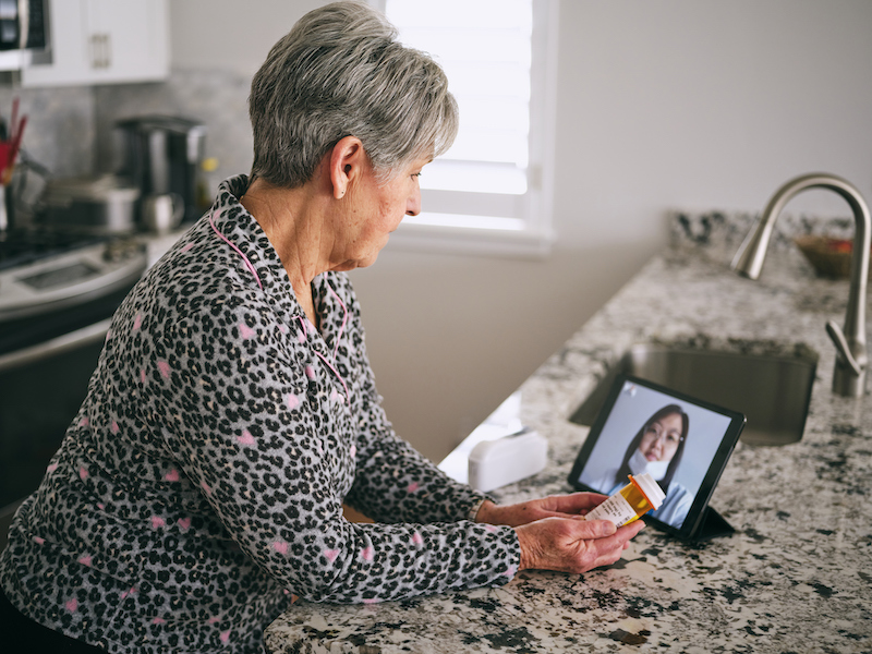 An older woman gets an exam via virtual visit. 
