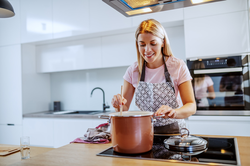 A woman cooks a one-pot recipe. 