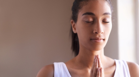 Female meditating at home