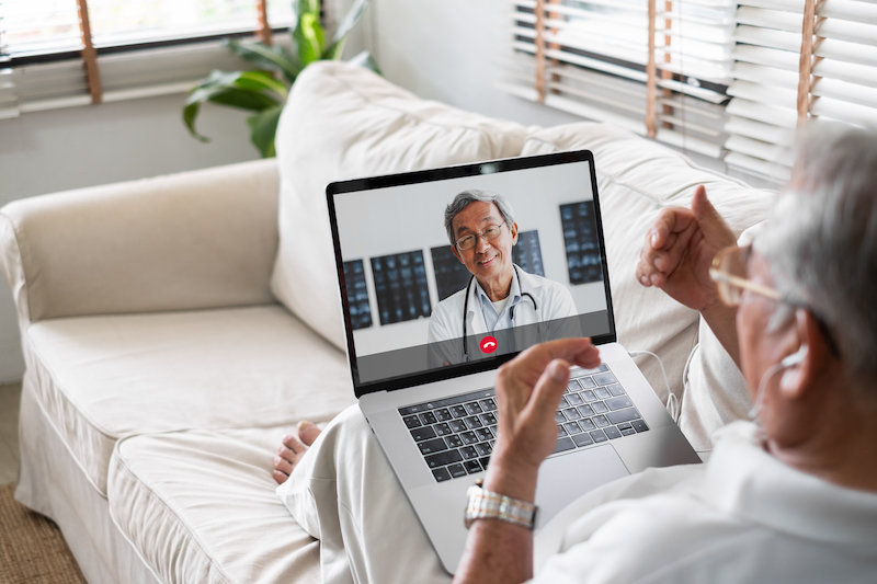 A man participates in a virtual visit with his doctor. 