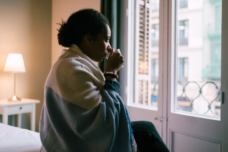 A woman sips coffee to start her morning. 