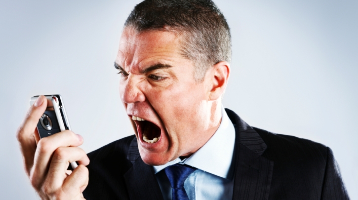 Man screaming into his phone. 