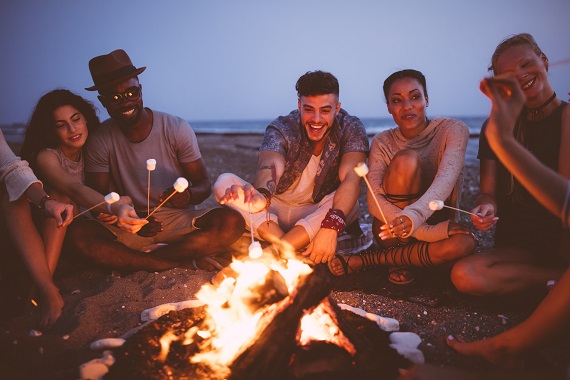 group of friends around a bonfire