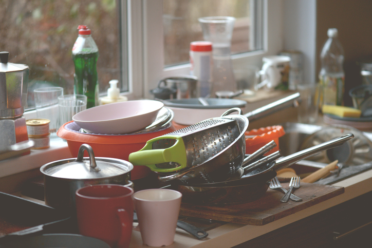 Dishes built up on a counter.