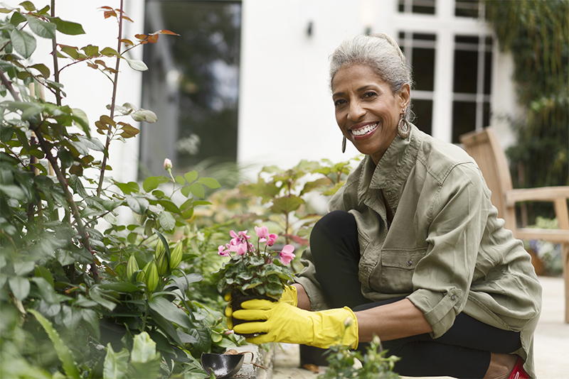 Woman gardening in her yard.