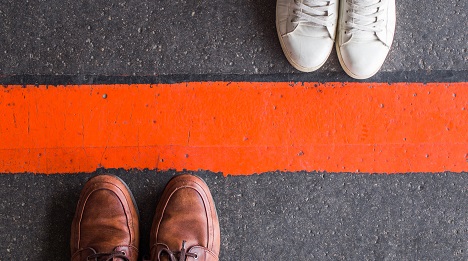 Two people separated by a line on the ground