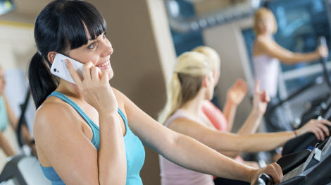 Woman on the phone at the gym