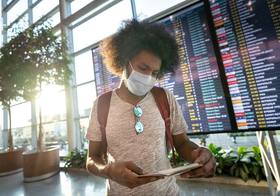 young man at airport checking travel plans