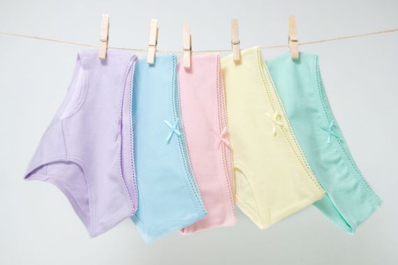 photo of five pairs of underwear on a clothing line