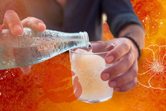 photo of man pouring a glass of sparkling water