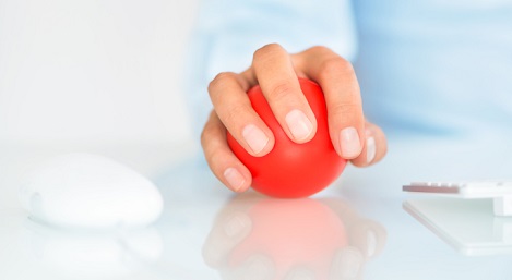 Worker holding a stress ball.