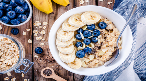 A warm bowl of oatmeal with blueberries.