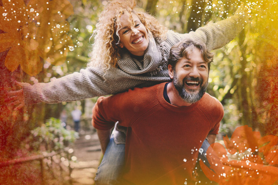 Man carrying woman on his shoulders