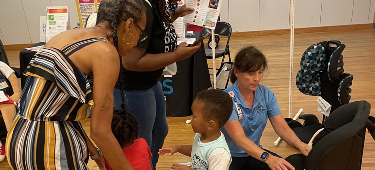 Event attendees receive car seat safety instruction