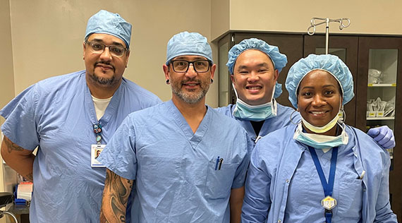 A surgeon standing with operating room staff
