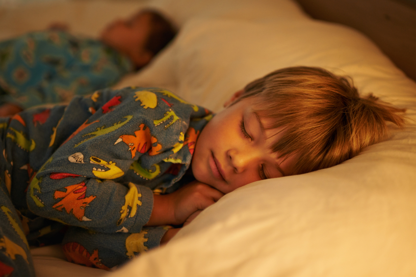 Child sleeping in bed.