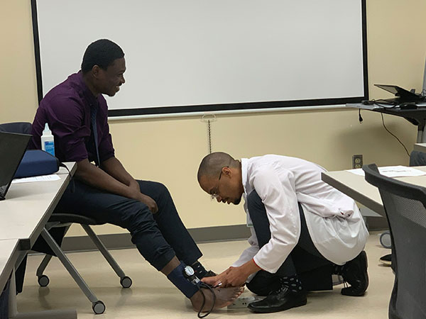 Primary Care team member taking someone's blood pressure