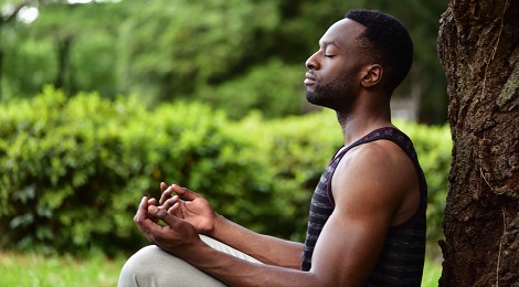 Man meditating outside.